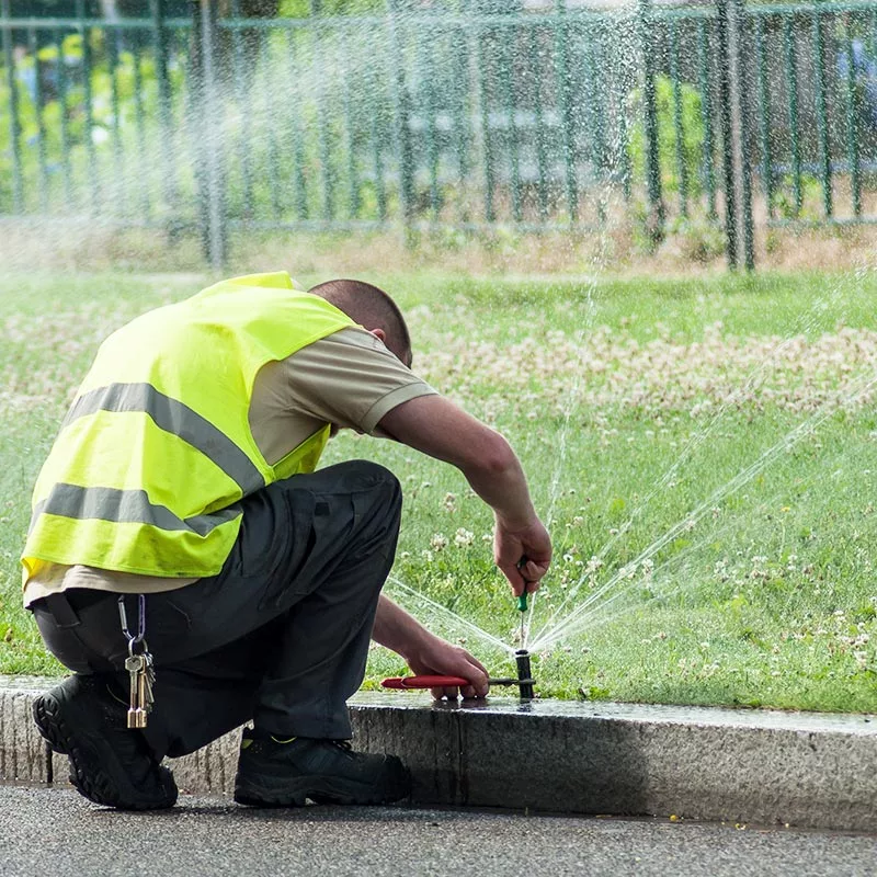 Irrigation VIP sprinkler system opening technician adjusting sprinkler